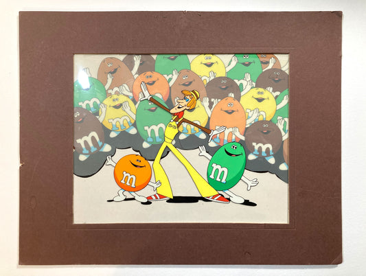 A magical set of 4 original animation cels, carefully assembled in a vintage mat board, forming a complete scene from a 1970s U.S. M&M’s commercial. For sale on FLIP Gallery