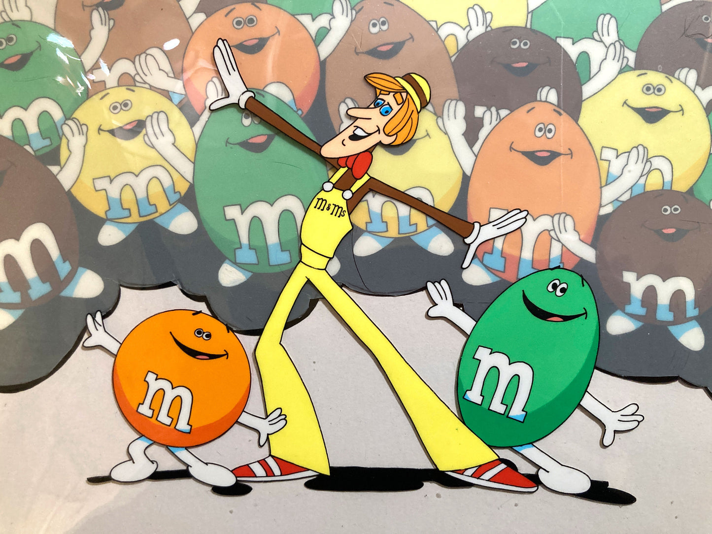 A magical set of 4 original animation cels, carefully assembled in a vintage mat board, forming a complete scene from a 1970s U.S. M&M’s commercial. For sale on FLIP Gallery